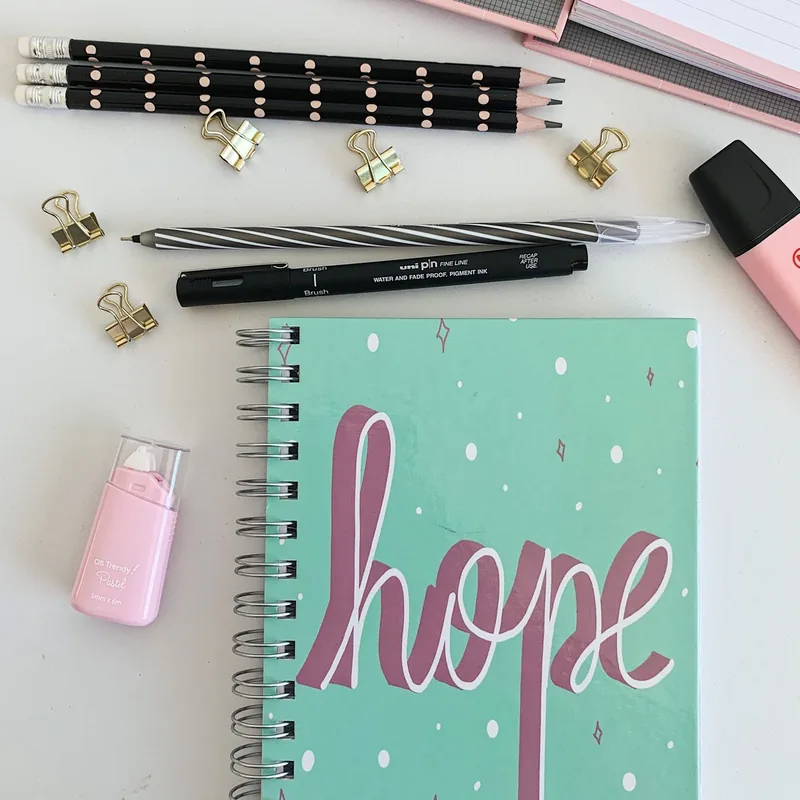 School notebooks, pens and supplies on a desk