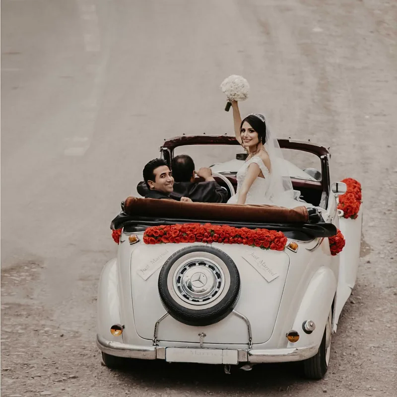 A decorated white car for an Indian wedding