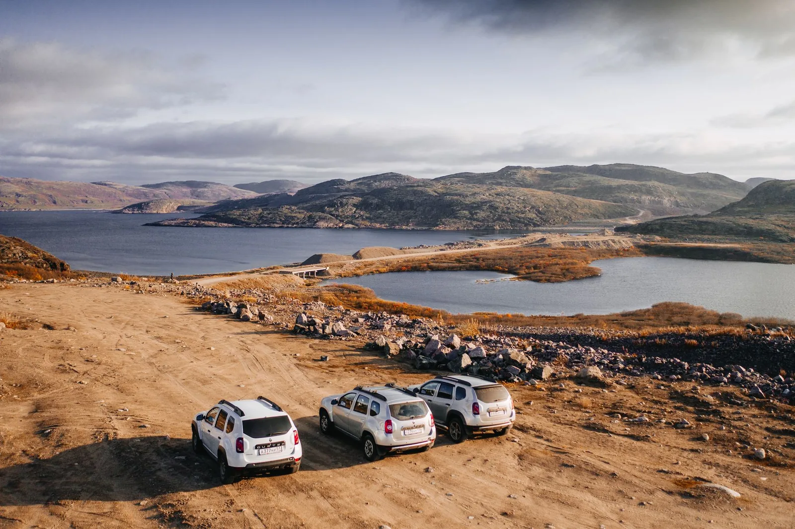 A clean white taxi on an open road, ready for an outstation trip