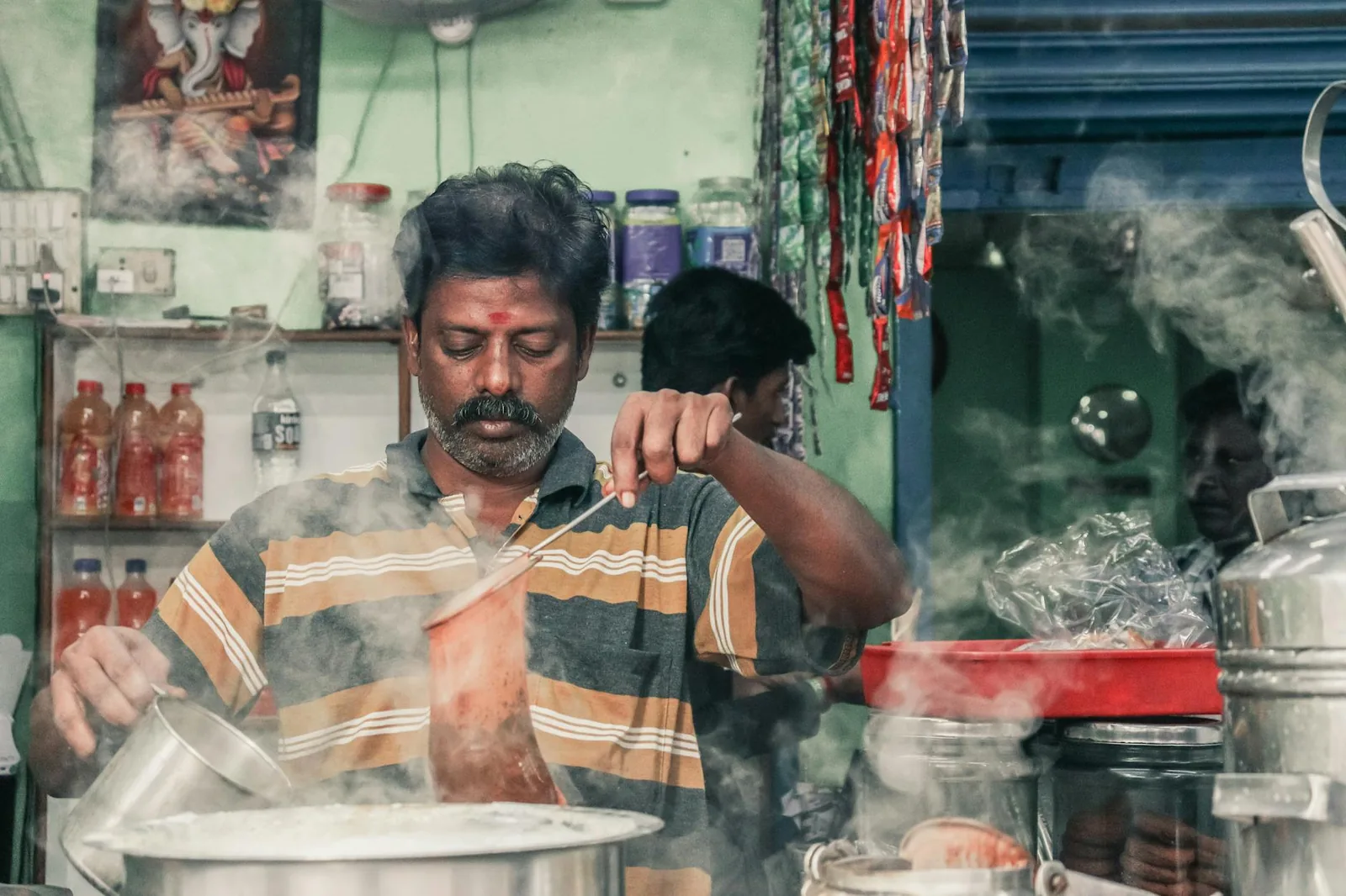 Steaming cups of Indian masala chai being prepared at a Chaileela café