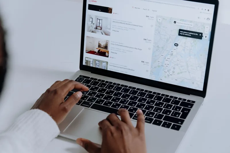 Travel booking platform interface on a laptop