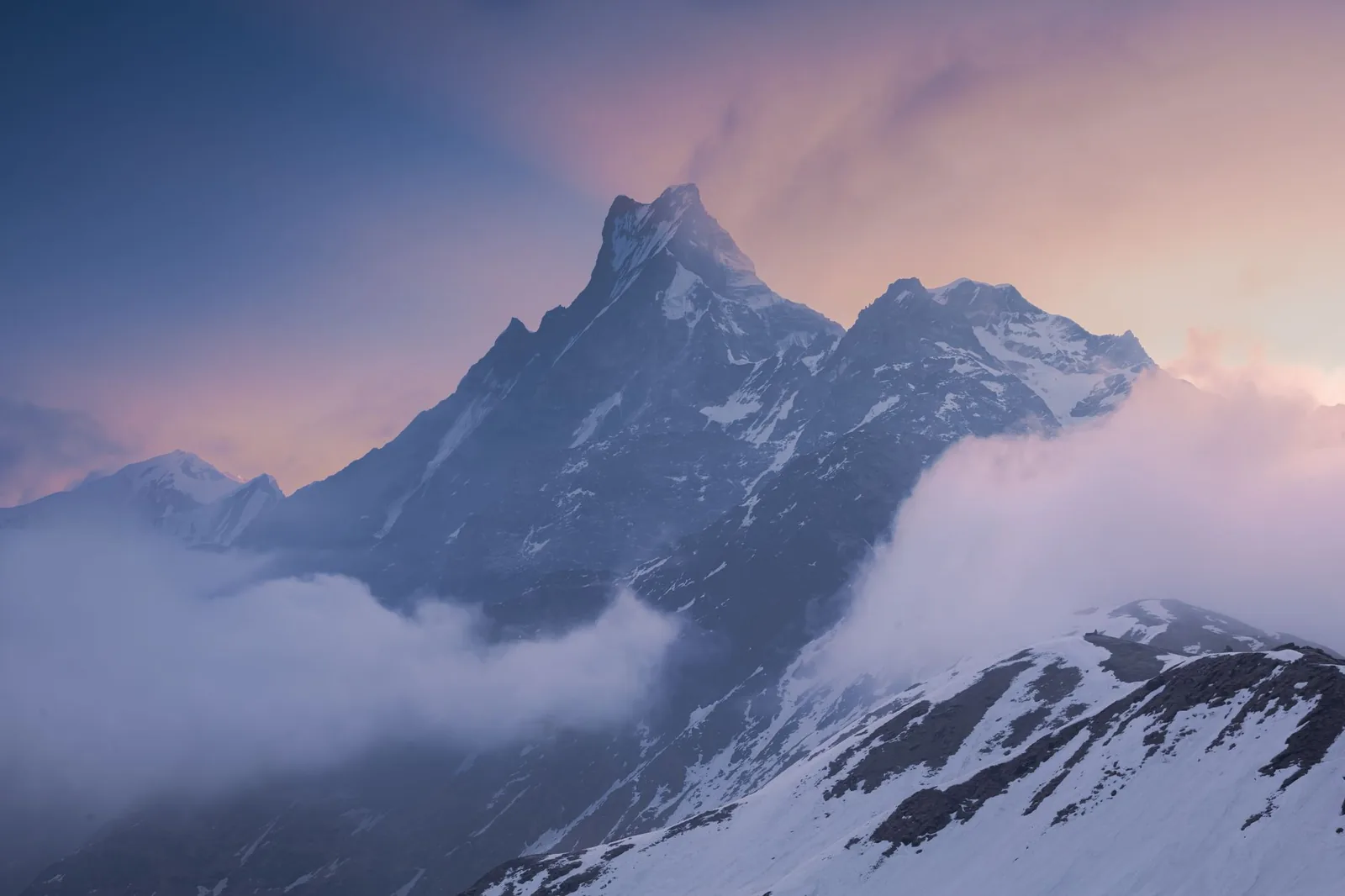 Snow-lit Himalayan peaks at sunset above a high mountain trail