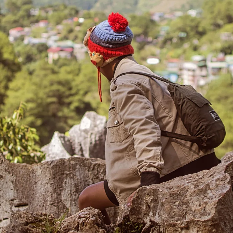 A Himalayan trek guide standing on a high mountain trail