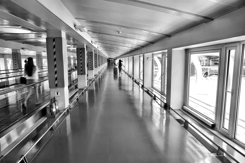 Traveller walking through a bright modern airport terminal