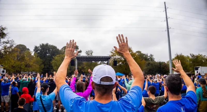 Crowd with raised hands at an outdoor brand activation