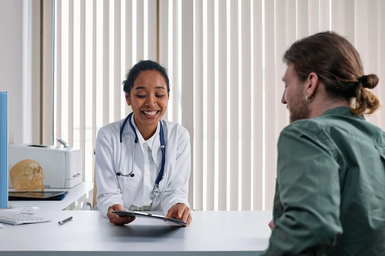 Dr. Kapoor listening warmly to a patient during a consultation