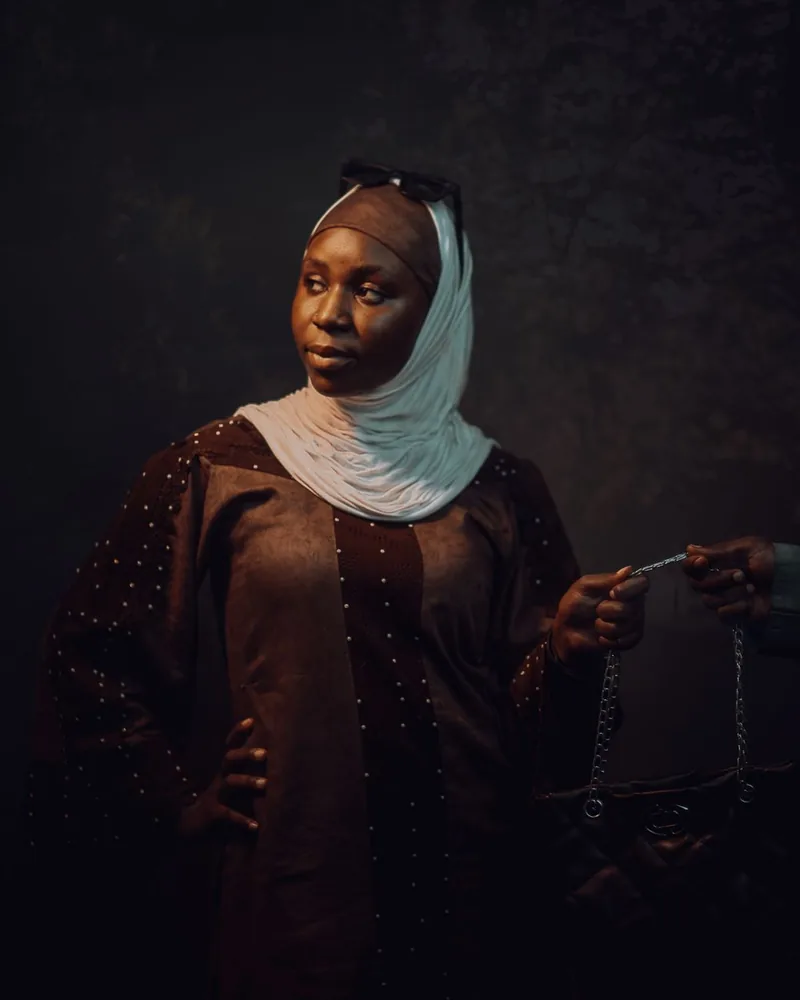 Confident woman carrying a Miraggio handbag in warm editorial light