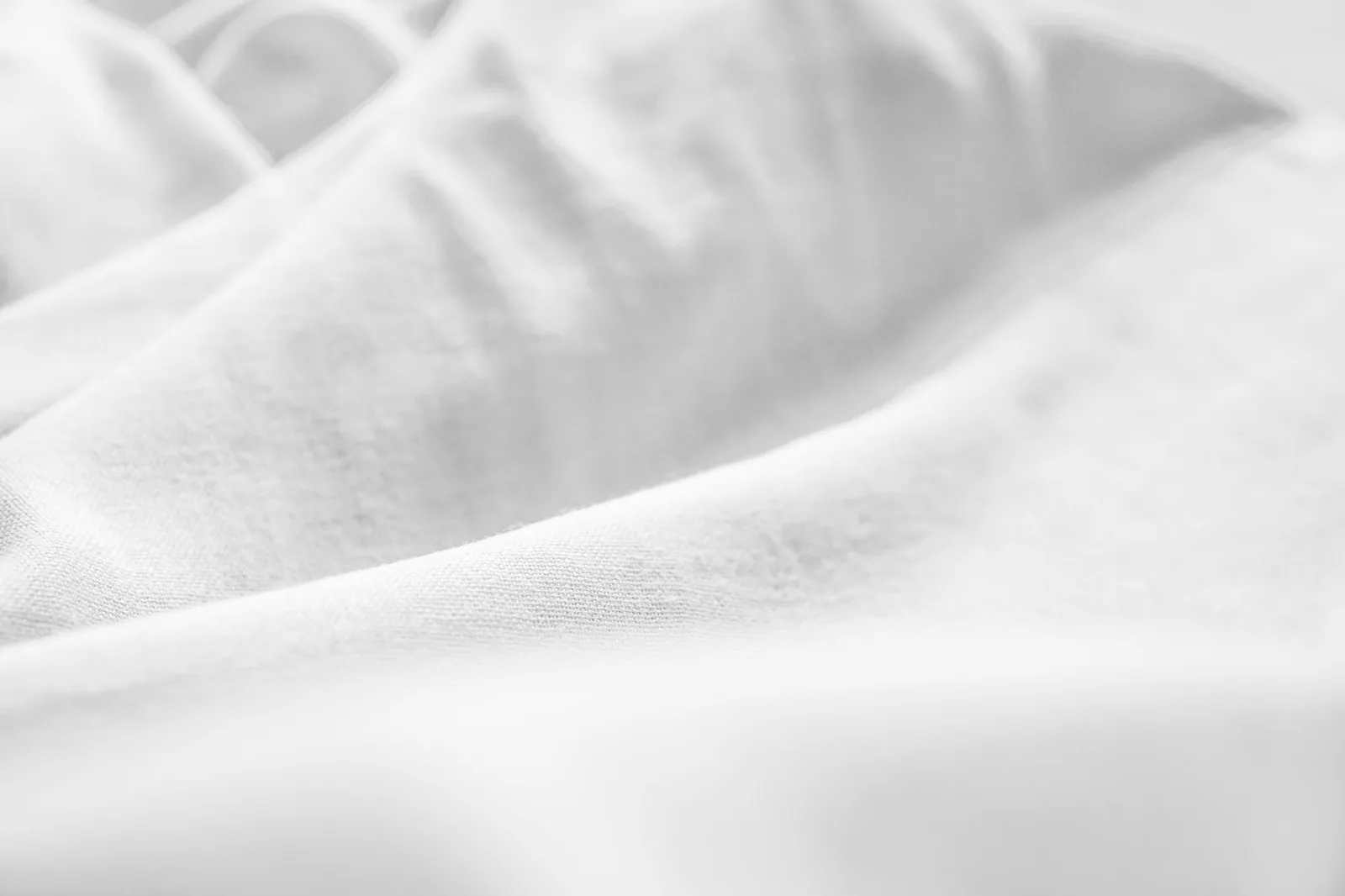 Soft folds of natural cotton fabric in warm light