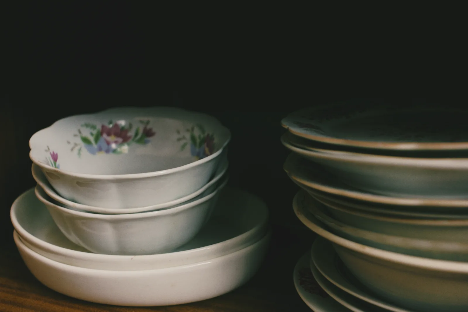 Stacked crockery and dinnerware in a warm kitchen