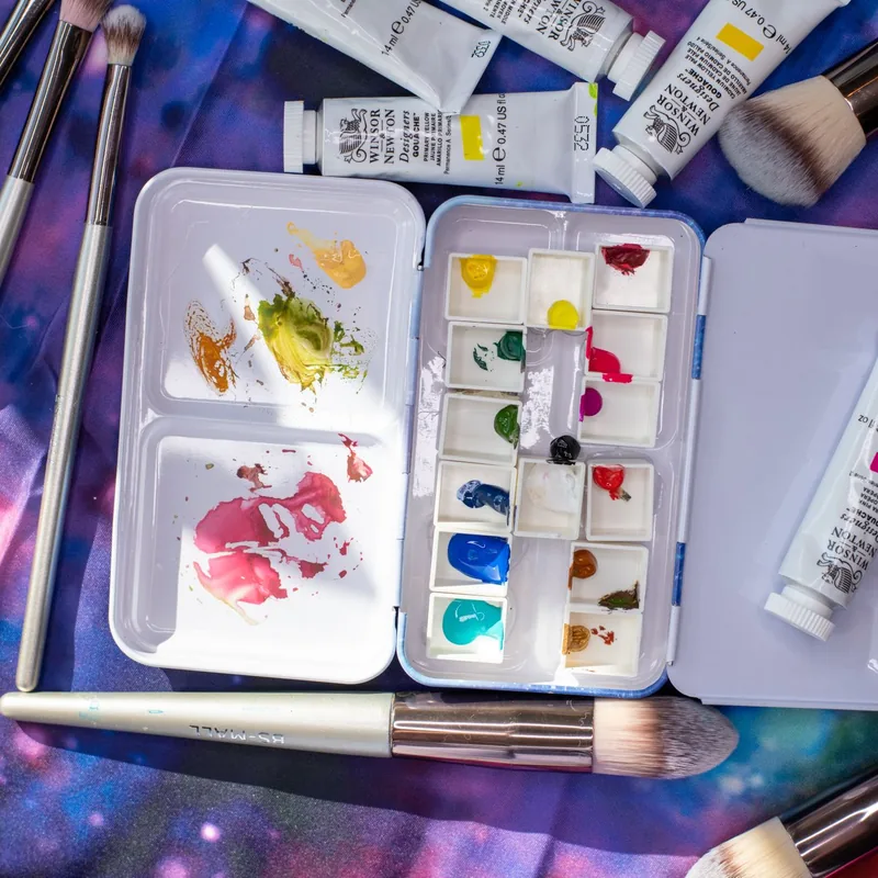 Paint brushes and watercolour palette