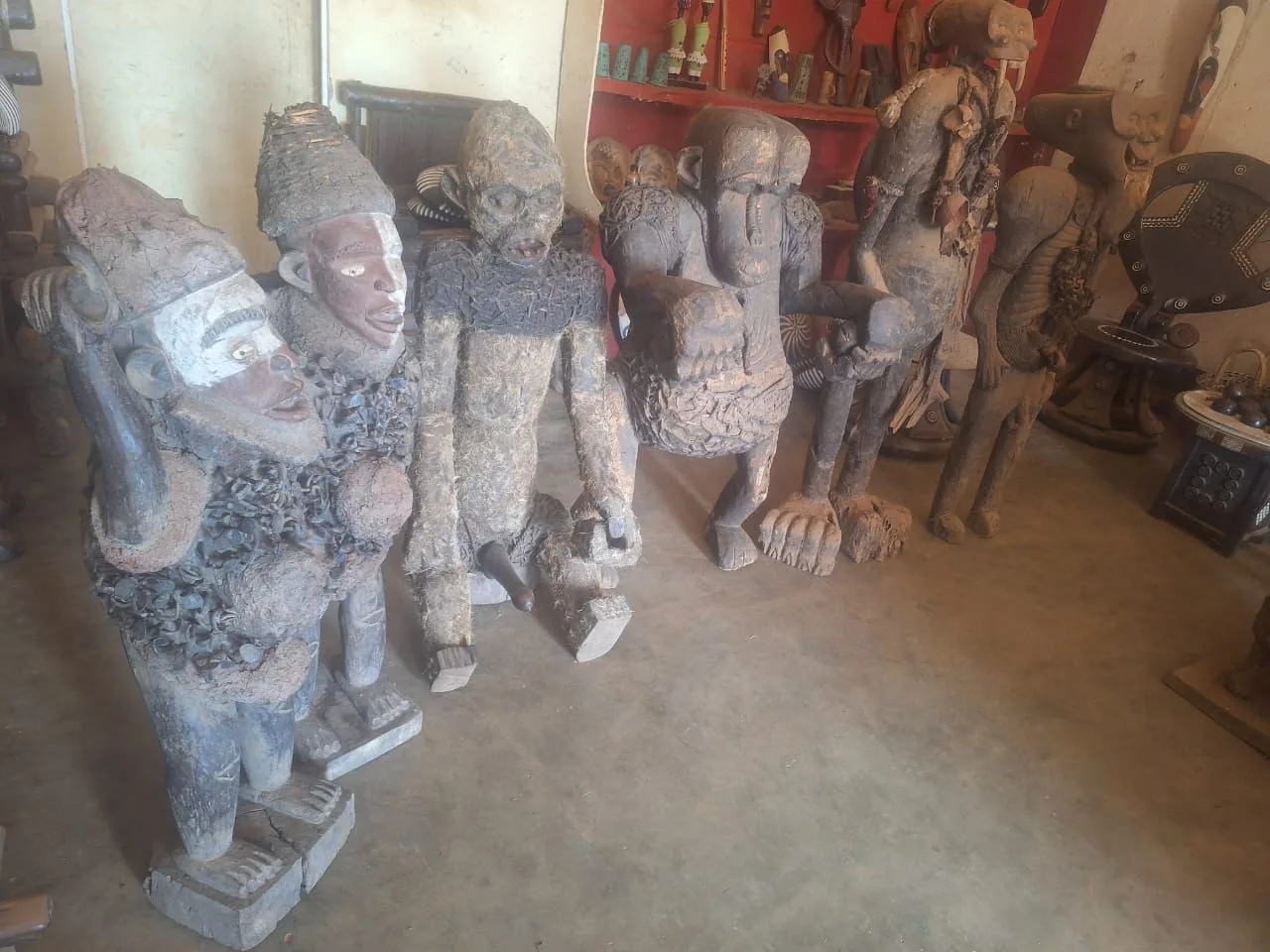 A gallery of carved African figures, masks and a carved throne