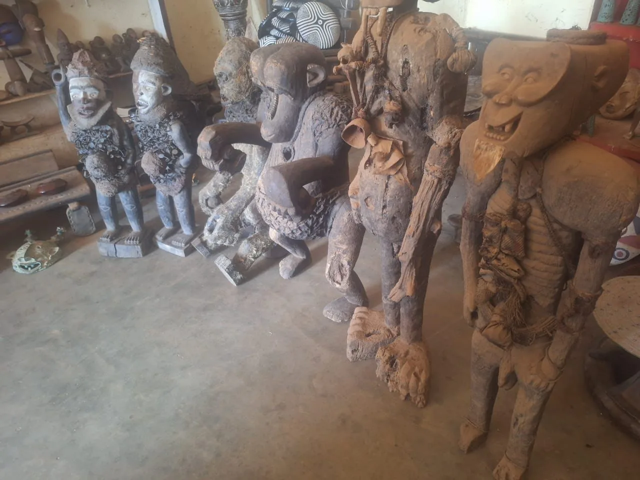 Large carved African statues in a workshop