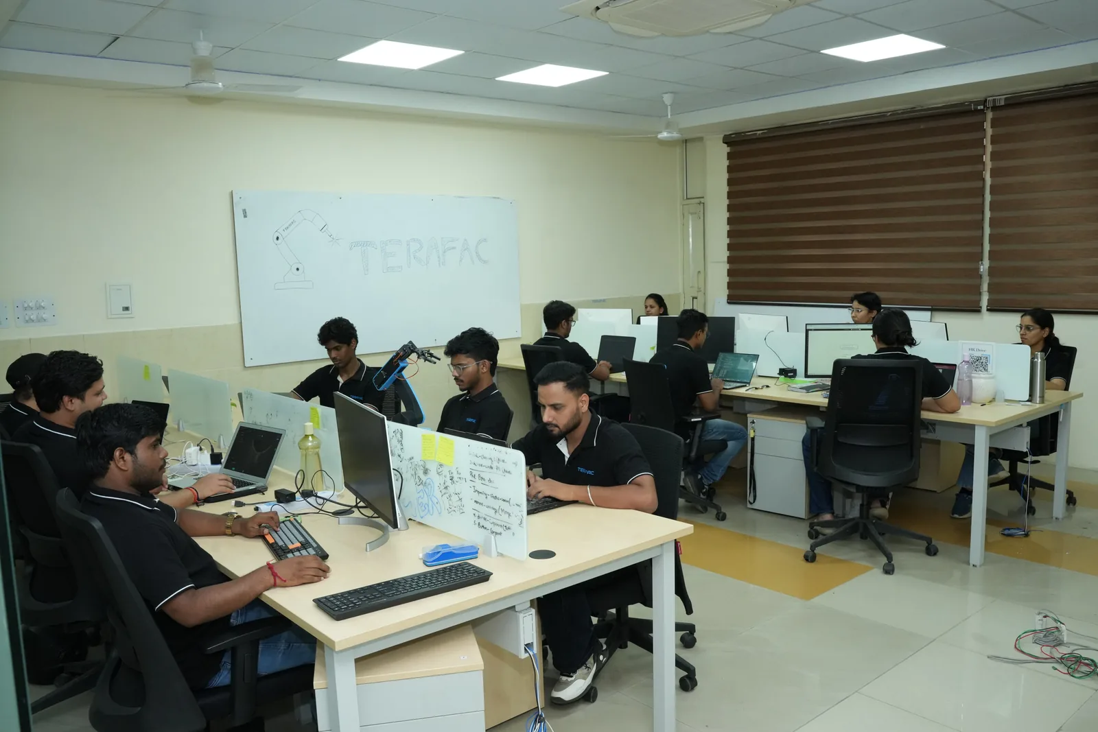 Engineers learning hands-on at workstations in a Terafac lab