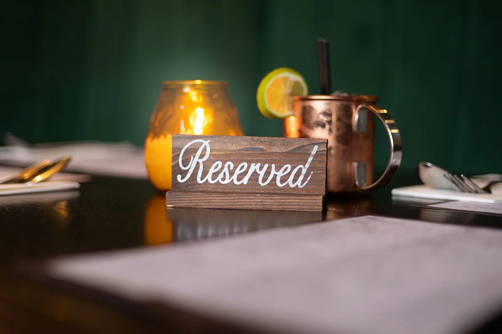 A candlelit restaurant table set for dinner